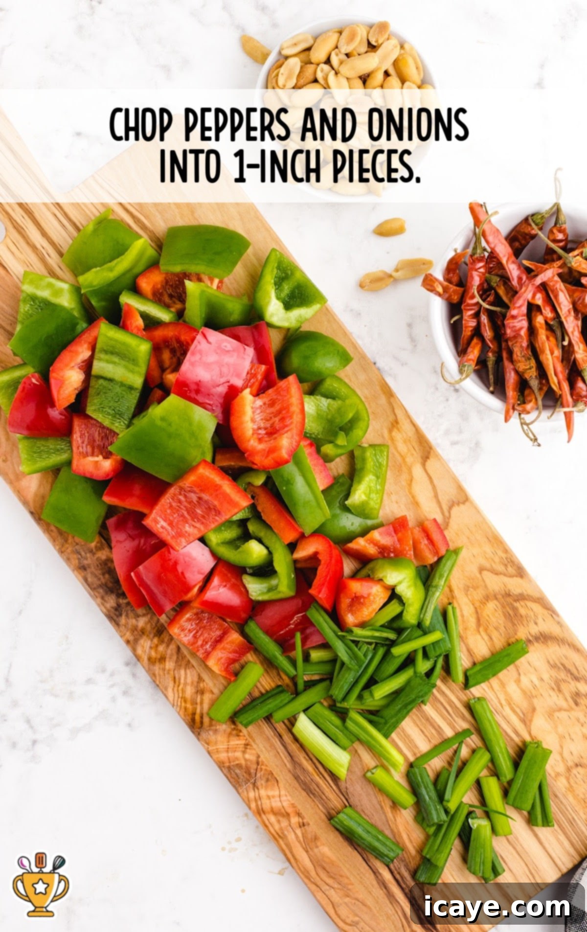 Sichuan Chili Peanut Chicken 6 peppers and onions chopped on a wooden board